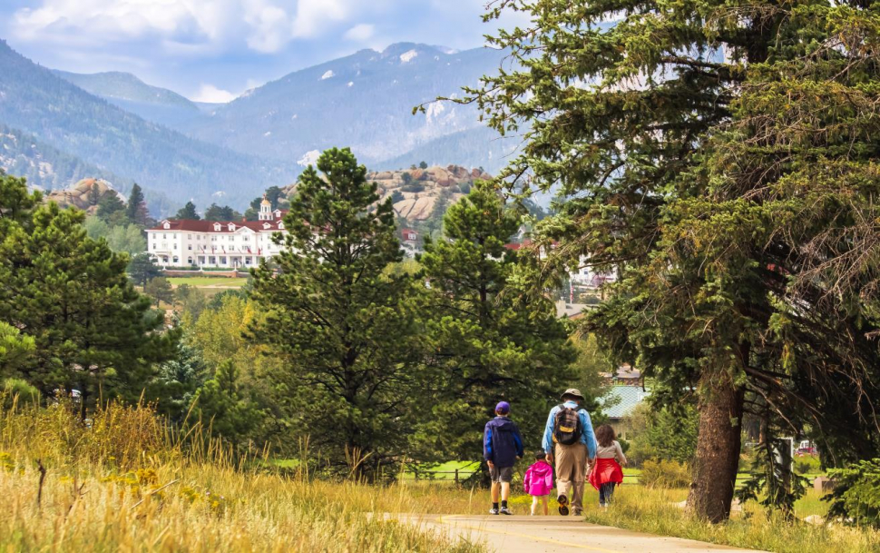 A family of four walking down a path in the outdoors of Colorado