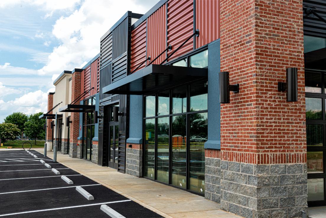 Row of empty storefronts that are up for sale